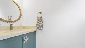 Blue bathroom vanity with gold mirror and marble countertop Oakville