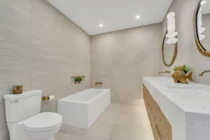 Luxury bathroom renovation with freestanding tub and beige textured wall tiles Oakville