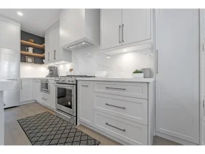 White kitchen renovation with modern cabinets and tile backsplash Oakville